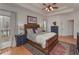 Bright main bedroom with a large bed, ceiling fan, and ensuite bathroom access at 9445 Grande Dr, Winston, GA 30187