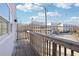 Spacious outdoor balcony with wooden railing offering a view of the neighborhood at 2000 Ocean Nw Dr, Atlanta, GA 30318