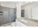 Modern bathroom featuring a glass enclosed shower with gray tiling and granite countertop at 2000 Ocean Nw Dr, Atlanta, GA 30318