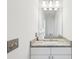 Modern bathroom with a white vanity, granite countertop, and stylish lighting fixture at 2000 Ocean Nw Dr, Atlanta, GA 30318