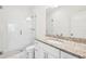 Bright bathroom featuring a granite countertop vanity, a large mirror, and a glass-enclosed shower at 2000 Ocean Nw Dr, Atlanta, GA 30318