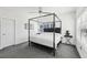 Bright bedroom with a four poster bed, side table, and ample natural light at 2000 Ocean Nw Dr, Atlanta, GA 30318