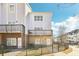 Townhouse featuring multiple balconies, a secure fence, and attractive landscaping at 2000 Ocean Nw Dr, Atlanta, GA 30318