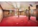 The partially finished basement has wood paneling and red carpet at 448 Buckingham Dr, Marietta, GA 30066
