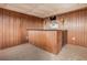 This partially finished basement has wood paneling and tan carpet at 448 Buckingham Dr, Marietta, GA 30066