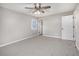 Bedroom with a ceiling fan, window, and closet door, providing ample space and natural light at 448 Buckingham Dr, Marietta, GA 30066