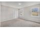 Carpeted bedroom with closet doors, natural light, and neutral paint offering a versatile space at 448 Buckingham Dr, Marietta, GA 30066