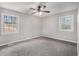 Neutral bedroom with carpet, two windows for natural light, and a ceiling fan for added comfort at 448 Buckingham Dr, Marietta, GA 30066