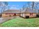 Charming brick home with a well-manicured lawn, red shutters, and a two-car garage at 448 Buckingham Dr, Marietta, GA 30066