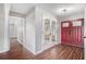 Welcoming foyer featuring a stylish red door, glass paneled french doors, and hardwood floors at 448 Buckingham Dr, Marietta, GA 30066
