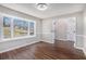 Inviting room with hardwood floors, wainscoting, and a large bay window overlooking the backyard at 448 Buckingham Dr, Marietta, GA 30066