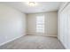 Bedroom features natural lighting, neutral paint and carpet, and closet at 835 Old Rocky Rd, Atlanta, GA 30349