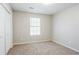 Bedroom features natural lighting, neutral paint and carpet, and closet at 835 Old Rocky Rd, Atlanta, GA 30349