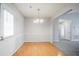 Bright dining room with wood floors, featuring a modern chandelier and ample natural light at 835 Old Rocky Rd, Atlanta, GA 30349