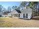 The side of this single-story house features white siding and an expansive lawn at 835 Old Rocky Rd, Atlanta, GA 30349