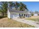 Attached single-car garage with a clean concrete driveway and manicured landscaping at 835 Old Rocky Rd, Atlanta, GA 30349
