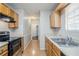 Efficient kitchen with appliances and wood cabinetry, offering ample space for meal preparation at 835 Old Rocky Rd, Atlanta, GA 30349