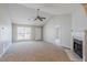 Bright living room featuring vaulted ceiling, fan, fireplace and neutral carpet at 835 Old Rocky Rd, Atlanta, GA 30349