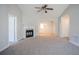Bright living room with a fireplace, neutral carpet, and an open layout, ideal for relaxing or entertaining at 835 Old Rocky Rd, Atlanta, GA 30349