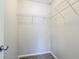 Walk-in closet with carpet flooring and metal storage shelves at 835 Old Rocky Rd, Atlanta, GA 30349