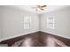 This bedroom features hardwood floors, trim, and two windows at 2506 Maple St, East Point, GA 30344