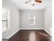 An airy bedroom with hardwood floors, a ceiling fan, and lots of natural light at 2506 Maple St, East Point, GA 30344