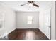 A bright bedroom with hardwood floors, a ceiling fan, and two windows at 2506 Maple St, East Point, GA 30344