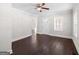 Living room with hardwood floors, ceiling fan, and freshly painted walls at 2506 Maple St, East Point, GA 30344