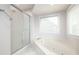 Bathroom features a soaking tub, separate shower, and a window with blinds allowing plenty of natural light at 2533 Briers North Dr, Atlanta, GA 30360