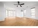 Bedroom with wood floors, ceiling fan, large windows, and neutral walls create a bright and airy space at 2533 Briers North Dr, Atlanta, GA 30360