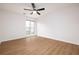 Bedroom with wood floors, ceiling fan, white walls, and a window create a minimalist and peaceful retreat at 2533 Briers North Dr, Atlanta, GA 30360