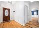 Home foyer features a wood door with leaded glass, wood floors, wainscotting, and view into other rooms at 2533 Briers North Dr, Atlanta, GA 30360