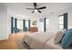 Main bedroom with hardwood floors, ceiling fan, bay window, and decor create a warm and inviting space at 2533 Briers North Dr, Atlanta, GA 30360