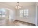 Bright dining room with natural light, wood floors, and modern chandelier fixture at 3291 Quincey Xing, Conyers, GA 30013