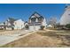 Charming two-story home with a two-car garage and manicured front yard on a sunny day at 3291 Quincey Xing, Conyers, GA 30013