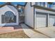 Close up of the home's entryway and two-car garage with white doors and black trim at 3291 Quincey Xing, Conyers, GA 30013