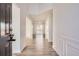 Bright foyer with light wood floors and white wainscoting leading to the rest of the home at 3291 Quincey Xing, Conyers, GA 30013