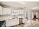 Well lit kitchen featuring stainless steel appliances, white cabinets, and lovely wood floors at 3291 Quincey Xing, Conyers, GA 30013