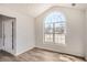 Bright living room featuring a large arched window and light wood floors throughout at 3291 Quincey Xing, Conyers, GA 30013