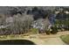 Expansive luxury home overlooking lush green golf course and pond, surrounded by trees at 1460 Lakemist Ct, Roswell, GA 30075