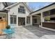 Beautiful backyard patio with stylish blue chairs, elegant gray tiles, and access to the home's interior at 1460 Lakemist Ct, Roswell, GA 30075