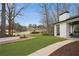 Expansive backyard with lush artificial grass and scenic views of a golf course and serene lake at 1460 Lakemist Ct, Roswell, GA 30075