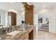 Spacious bathroom featuring a granite countertop vanity and a doorway leading to the main bedroom at 1460 Lakemist Ct, Roswell, GA 30075
