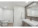 Modern bathroom features sleek vanity with gold hardware, tiled walls, and a glass shower at 1460 Lakemist Ct, Roswell, GA 30075