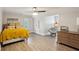 Spacious bedroom featuring wood floors, a ceiling fan, and a seating area with a gray papasan chair at 1460 Lakemist Ct, Roswell, GA 30075