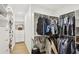 Walk-in closet with custom shelves and hanging rods for optimal organization and storage solutions at 1460 Lakemist Ct, Roswell, GA 30075