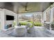 This covered patio features a beautiful stone fireplace, seating area, and outdoor bar with a view of the lake at 1460 Lakemist Ct, Roswell, GA 30075