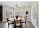 Dining room with modern light fixture, plantation shutters, and seating for six, creating a stylish and inviting space at 1460 Lakemist Ct, Roswell, GA 30075