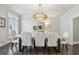 Elegant dining room features stylish lighting, seating for six, and large window for natural light at 1460 Lakemist Ct, Roswell, GA 30075