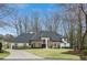 Elegant stone and white home with a well-manicured lawn and circular driveway, offering curb appeal at 1460 Lakemist Ct, Roswell, GA 30075